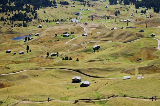 Valley with houses in Dolomite Alps, view from a mountain