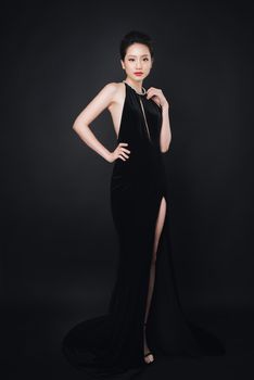 Asian woman with fashion makeup in luxury black dress.