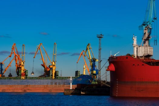 Blue cargo ship loading in the port of Riga, Europe