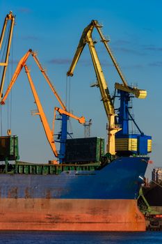 Blue cargo ship loading in the port of Riga, Europe