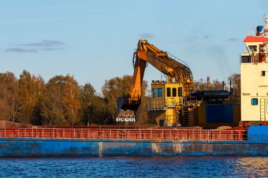 Blue cargo ship loading in the port of Riga, Europe