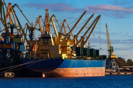 Blue cargo ship loading in the port of Riga, Europe