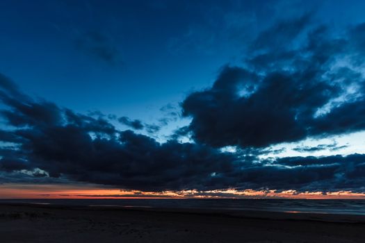 Blue cloudy sky over the Baltic sea at evening