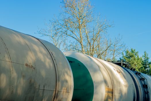 Tank wagons with oil. Freight train in forest