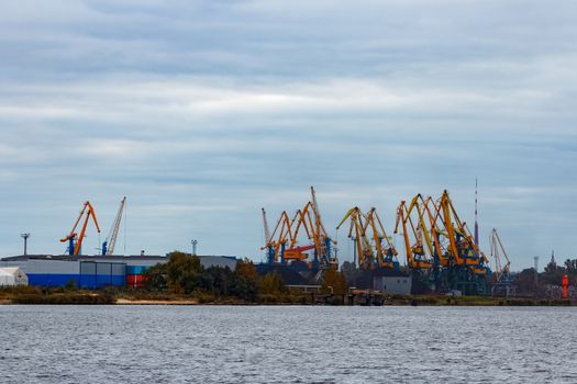 Yellow cargo cranes in the port of Riga, Europe