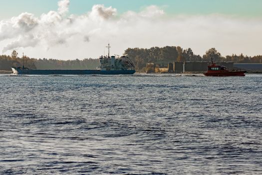 Blue cargo ship entering the port of Riga, Europe