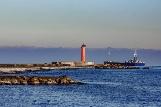 Blue cargo ship leaving Riga and entering Baltic sea