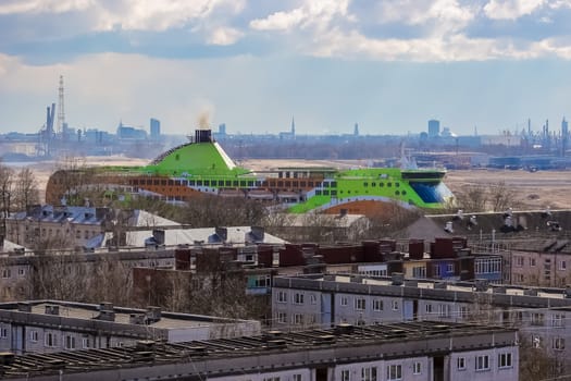 Green cruise liner. Passenger ferry sailing past the Riga city