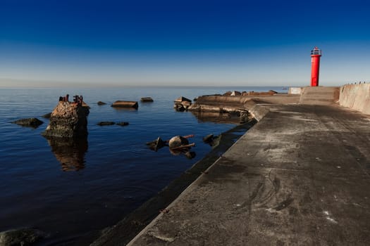 Red lighthouse on breakwater dam in Riga, Europe