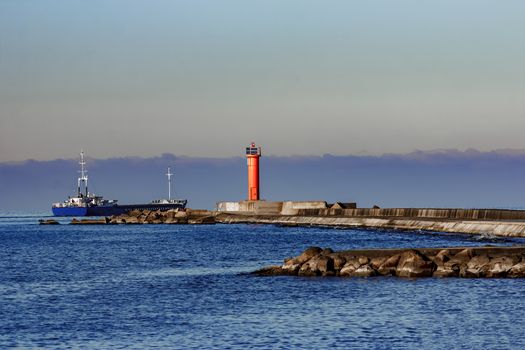 Blue cargo ship leaving Riga and entering Baltic sea