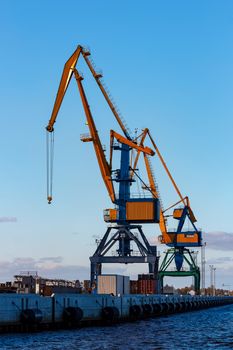 Yellow cargo cranes in the port of Riga, Europe