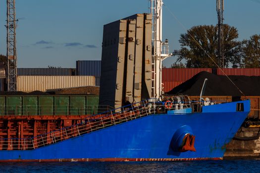 Blue cargo ship loading in the port of Riga, Europe