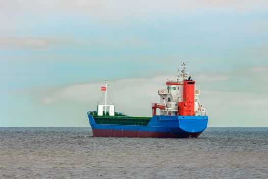 Blue cargo ship entering the Baltic sea. Riga, Europe