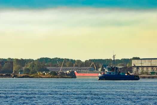 Blue small tug ship at the cargo port