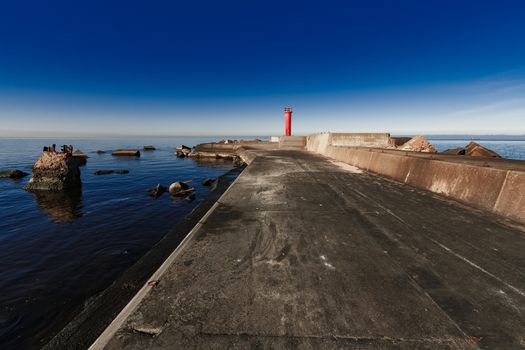 Red lighthouse on breakwater dam in Riga, Europe