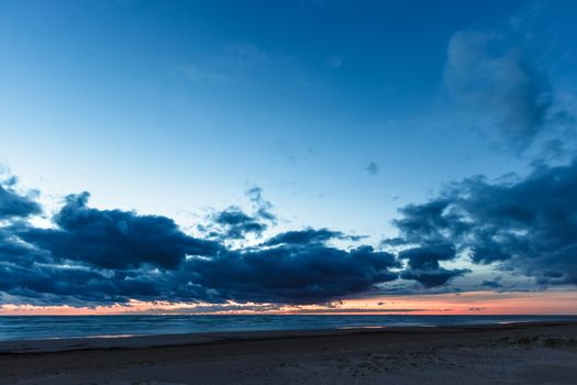 Blue cloudy sky over the Baltic sea at evening