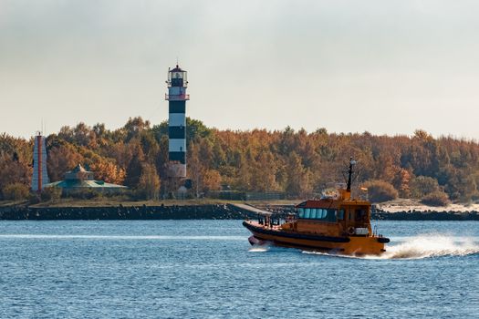 Yellow pilot ship moving at speed from the Baltic sea