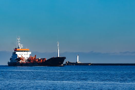 Black cargo oil tanker sailing in still water from Baltic sea