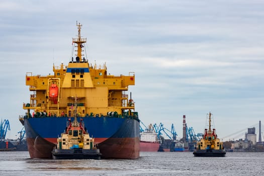 Blue cargo ship entering the port of Riga, Europe