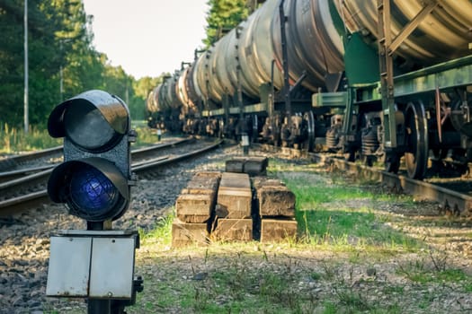 Railroad traffic light and freight train on behind