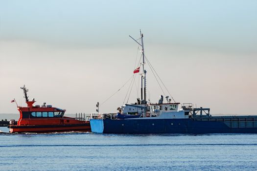 Blue cargo ship leaving Riga and entering Baltic sea