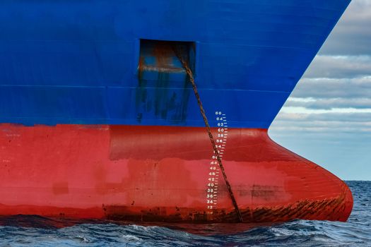 Blue cargo ship moored in still Baltic sea water