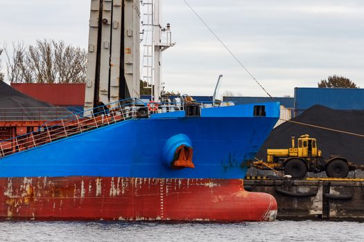 Blue cargo ship loading in the port of Riga, Europe