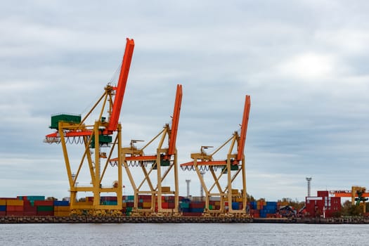 Yellow cargo cranes in the port of Riga, Europe