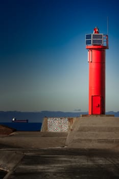 Red lighthouse on breakwater dam in Riga, Europe