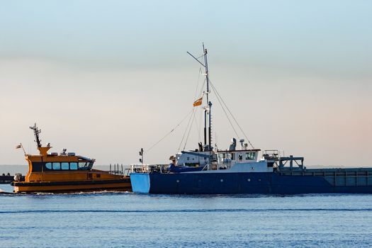 Blue cargo ship leaving Riga and entering Baltic sea