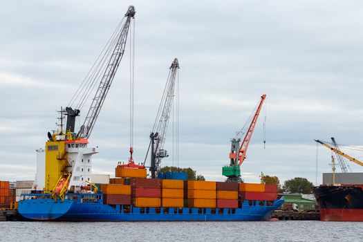 Blue container ship loading in cargo port of Europe