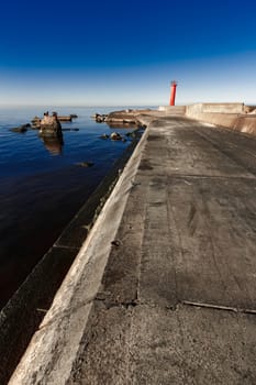 Red lighthouse on breakwater dam in Riga, Europe