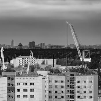 Residential area in Riga with soviet houses and cargo cranes