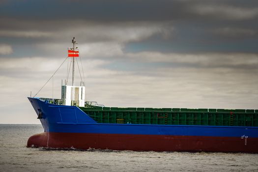 Blue cargo ship's bow leaving the port of Riga