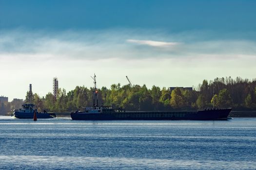 Blue cargo ship leaving Riga and entering Baltic sea