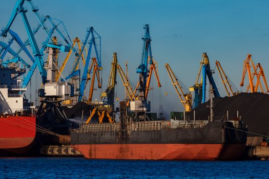 Black barge loading in cargo port of Riga