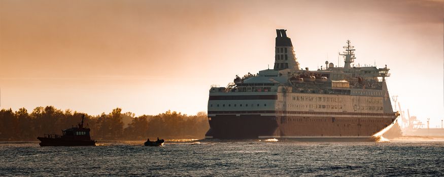 Big cruise liner. Passenger ferry ship entering Riga at morning