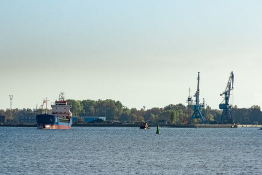 Blue cargo ship leaving the port of Riga