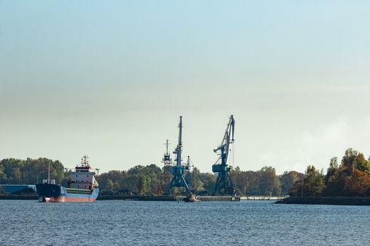 Blue cargo ship leaving the port of Riga