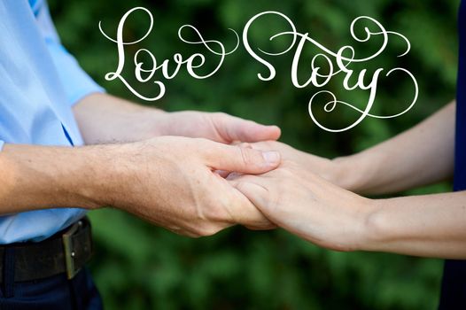 man is holding a woman hands for a walk in a summer park and vintage text Love story. Calligraphy lettering hand draw.