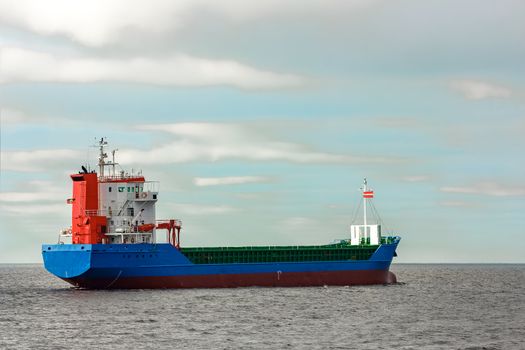 Blue cargo ship entering the Baltic sea. Riga, Europe