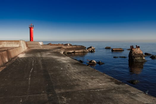 Red lighthouse on breakwater dam in Riga, Europe