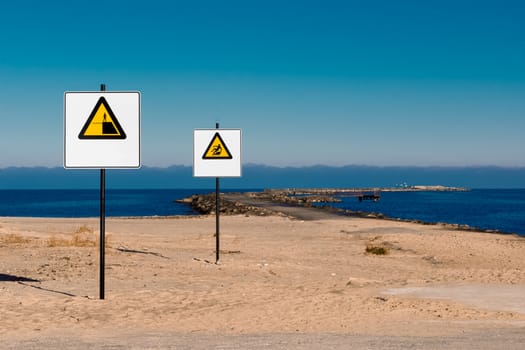 Yellow warning signs on summer beach, Riga