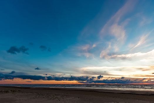 Blue cloudy sky over the Baltic sea at evening