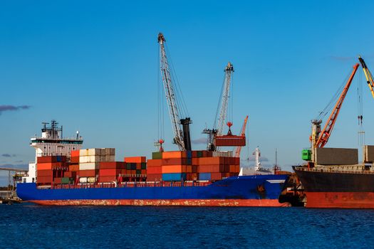 Blue container ship loading in cargo port of Europe