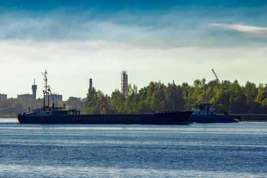 Blue cargo ship leaving Riga and entering Baltic sea