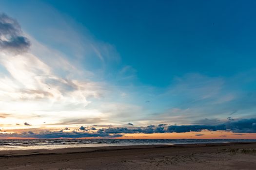 Blue cloudy sky over the Baltic sea at evening