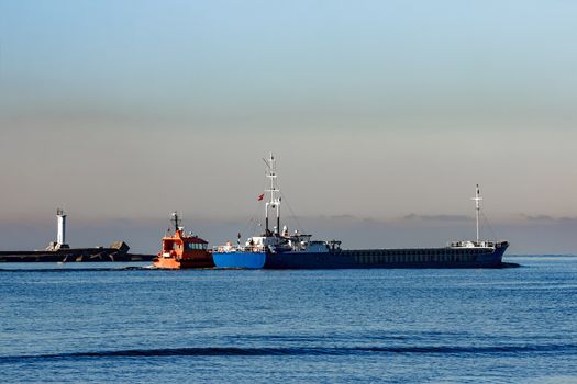 Blue cargo ship leaving Riga and entering Baltic sea