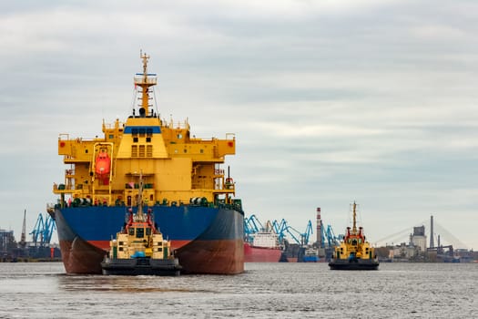 Blue cargo ship entering the port of Riga, Europe