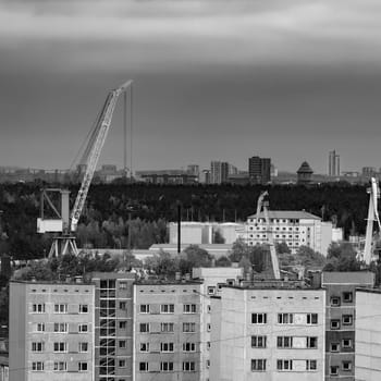 Residential area in Riga with soviet houses and cargo cranes